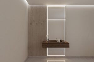 مدخل استقبال: الدليل الشامل لتصميم مداخل مثالية في السعودية 5 تسريحة مودرن بتصميم جداري أنيق تضم مرآة بإطار إضاءة LED مخفية، وحدة أدراج خشبية عائمة، وعلاقة ملابس جانبية، مناسبة لغرف النوم والمداخل العصرية في المنازل السعودية.