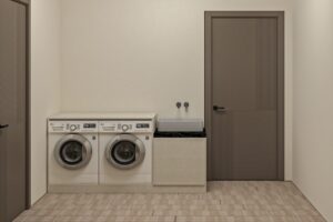 تصميم غرفة غسيل في الرياض: الدليل العملي لاختيار غرفة تخدمك 10 سنوات 3 غرفة غسيل مودرن بتصميم عملي تضم غسالة ونشافة مدمجتين، حوض غسيل جانبي بسطح رخامي أسود، وخزائن سفلية بتشطيب أنيق، مناسبة للمنازل السعودية.